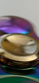 Close-up of colorful metallic spinner with gold and iridescent hues.