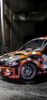 Sporty car with a geometric pattern in urban alley, featuring black and orange colors.