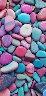 Colorful stones arranged as a mobile wallpaper, blending pink, purple, and cyan hues.