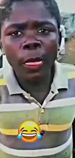 Boy wearing colorful striped shirt with laughing emoji.