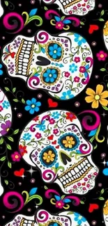 Colorful sugar skulls with florals on black background.