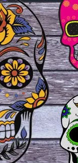 Colorful sugar skulls on wooden background.