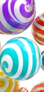 Colorful swirl candy spheres on white background.