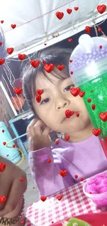 Child enjoying colorful drink at festive table.