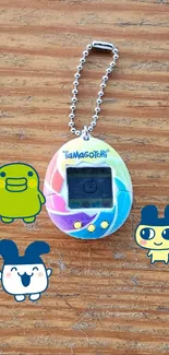 Colorful Tamagotchi with cartoon characters on wood.