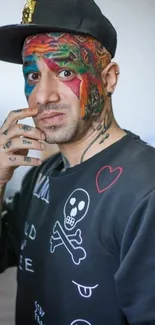 Portrait with colorful face tattoo and stylish black attire.