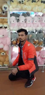 Man in orange jacket with colorful teddy bears