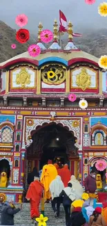 Vibrant temple entrance with colorful flowers and intricate designs.