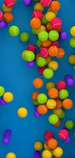 Cascade of colorful tennis balls on blue.