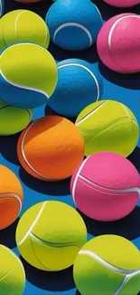 Colorful tennis balls on a blue background.