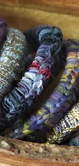 Intricate woven fabric pattern with vibrant colors in a wooden bowl.