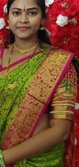 A woman in a colorful traditional saree with intricate designs.