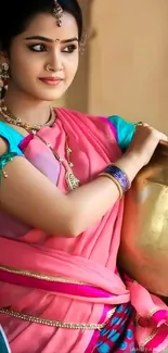 Woman in vibrant pink saree holding a pot, showcasing traditional elegance.