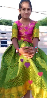 Person in vibrant traditional dress with scenic background.