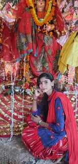 Woman in traditional attire amid vibrant festival decorations.