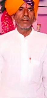 Man in traditional attire with colorful turban.