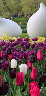 A vibrant tulip garden with colorful blossoms and serene sculptures.