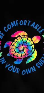 Vibrant rainbow turtle shell with motivational text on black background.