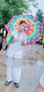 Young woman with colorful umbrella in a village scene.