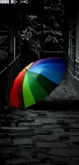 Colorful umbrella on a dark pathway background for mobile wallpaper.