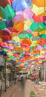 Colorful umbrellas suspended above a lively street scene.