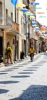 Charming street with colorful umbrellas hanging overhead.