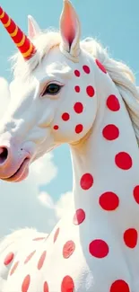 Colorful unicorn with red polka dots under a blue sky.