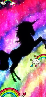 Silhouette of a unicorn against a colorful rainbow backdrop with whimsical clouds.