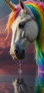 A unicorn with a rainbow mane stoops over water, under a vibrant sky.