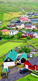 Aerial view of a colorful village on a lush green hillside