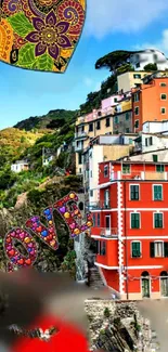 Colorful village with artistic love sign and scenic landscape.