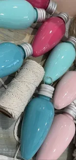 Assorted pastel vintage light bulbs on a textured surface.