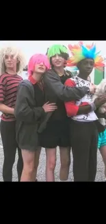 Group of friends with colorful wigs and playful outfits.