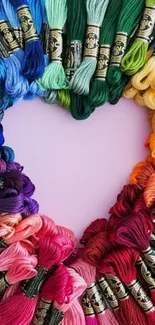 Colorful yarn forms a heart on a vibrant wallpaper.