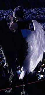 Concert scene with angel wings and lights.