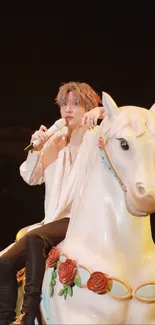 Person on carousel horse under stage lights at a concert.