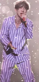 Performer in vibrant purple striped suit on stage.