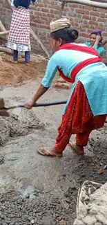 Women at a construction site mixing cement, vivid colors.