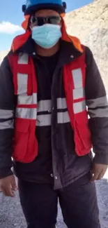 Construction worker in safety gear at a quarry site.