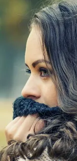 Woman in autumn setting, thoughtful and peaceful.