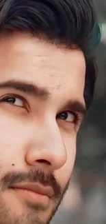 Close-up portrait of a contemplative man with blurred background.