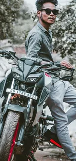 Biker posing with motorcycle in stylish attire.