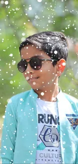 Boy in sunglasses with snow effect on turquoise background.