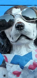 Dog with sunglasses and scarf on blue background.