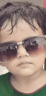 Adorable child wearing oversized sunglasses in a fun portrait.