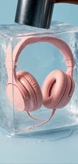 Pink headphones frozen in ice against a blue background.