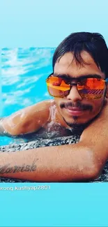 Man with orange sunglasses relaxing by the pool.