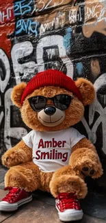 Teddy bear in a beanie and sunglasses with graffiti wall.