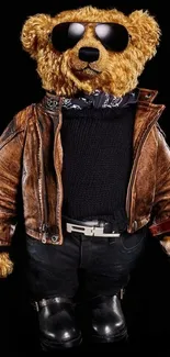 Stylish teddy bear in a leather jacket and sunglasses on a black background.