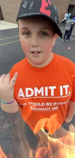 Person in orange shirt with urban backdrop, outdoors.